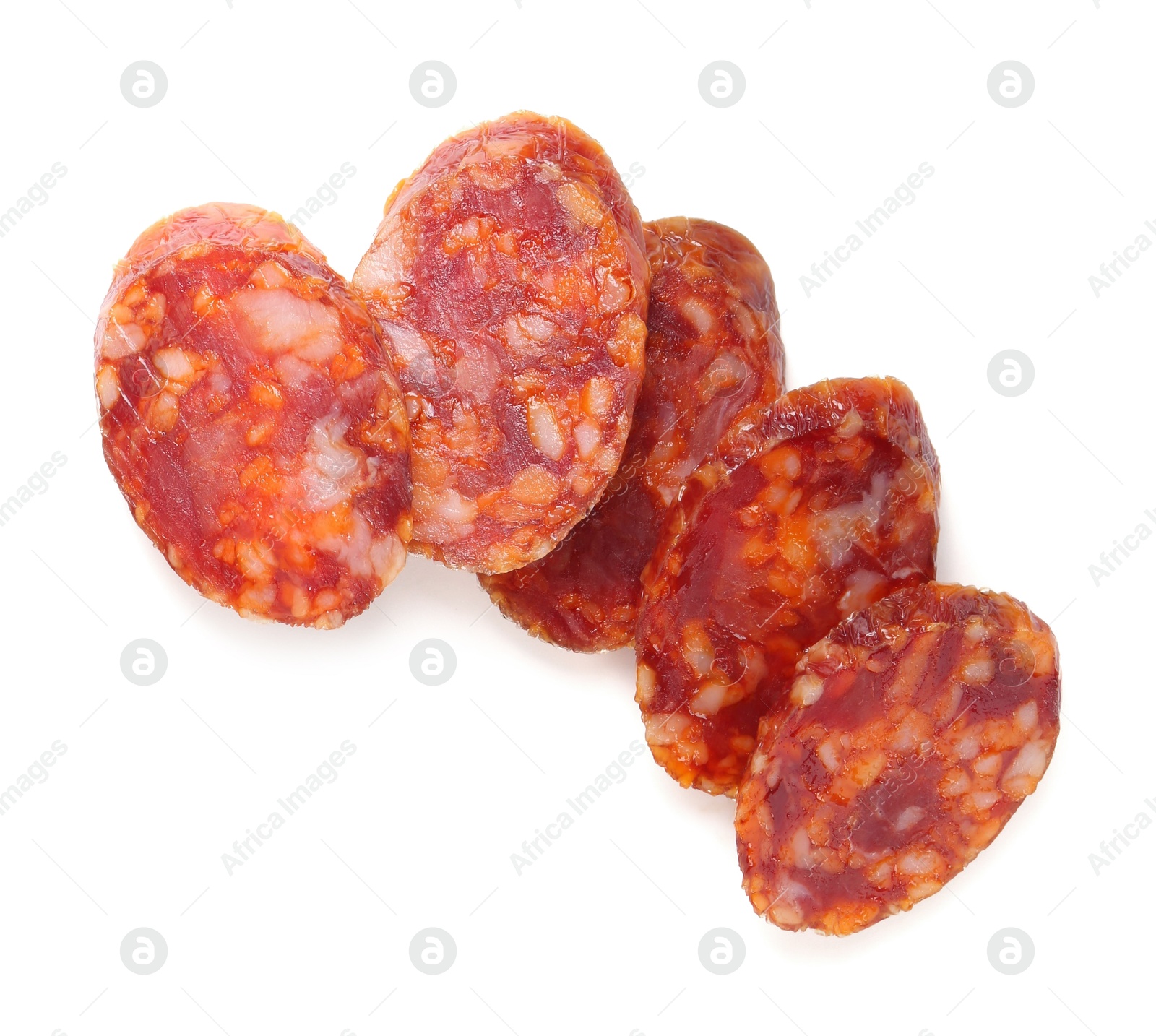 Photo of Pieces of delicious dry cured sausage isolated on white, top view