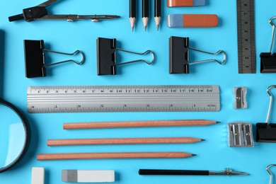 Photo of Flat lay composition with ruler and other stationery on light blue background