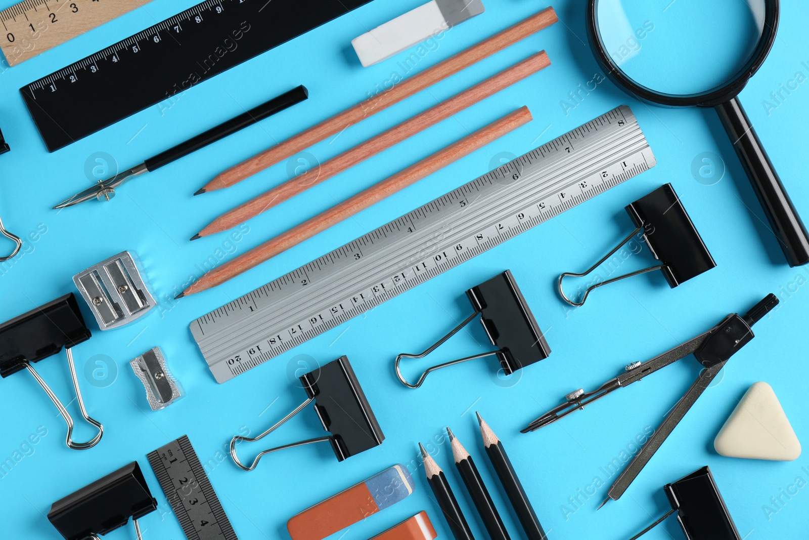 Photo of Flat lay composition with ruler and other stationery on light blue background