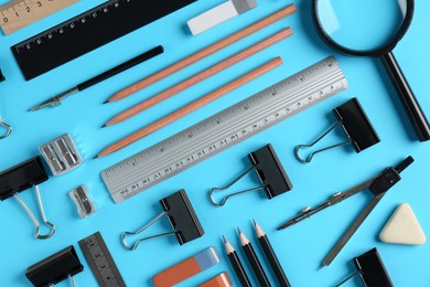 Photo of Flat lay composition with ruler and other stationery on light blue background