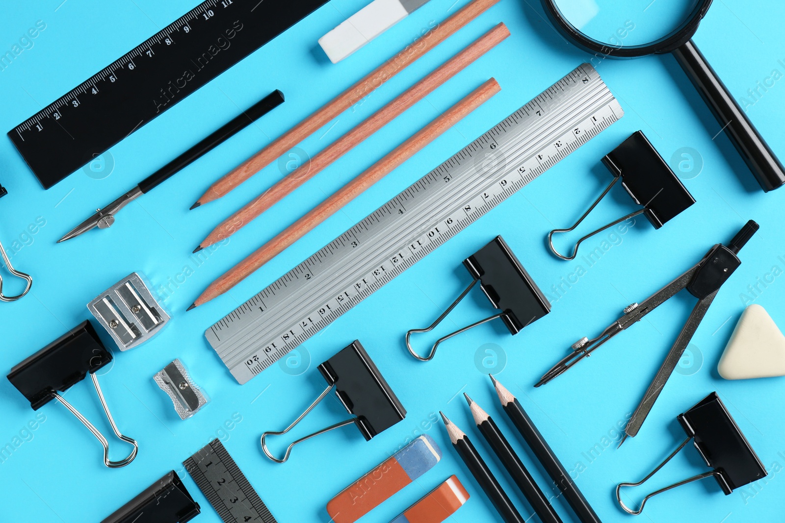 Photo of Flat lay composition with ruler and other stationery on light blue background