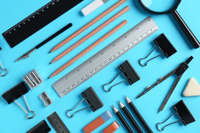 Photo of Flat lay composition with ruler and other stationery on light blue background