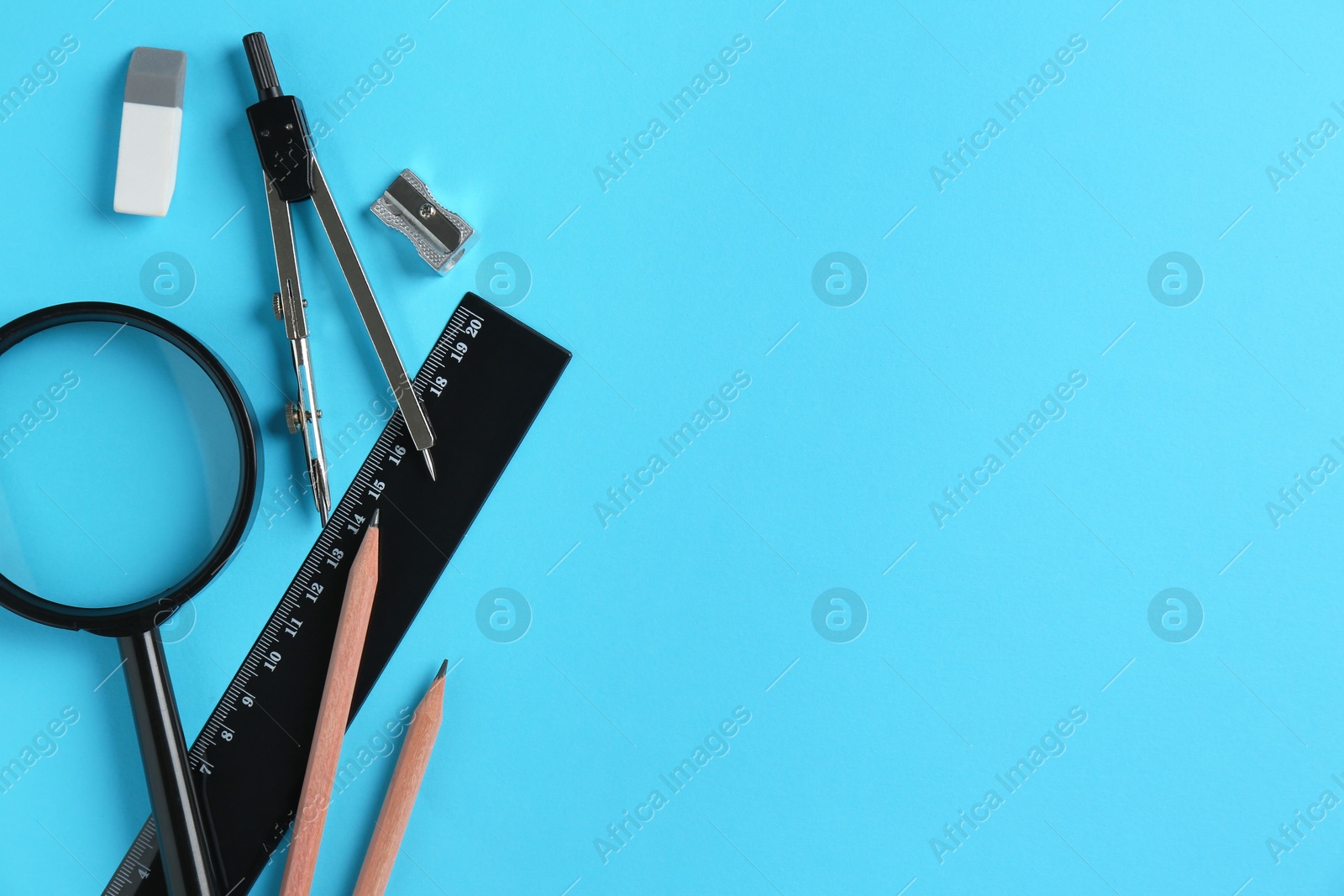 Photo of Flat lay composition with ruler and other stationery on light blue background, space for text