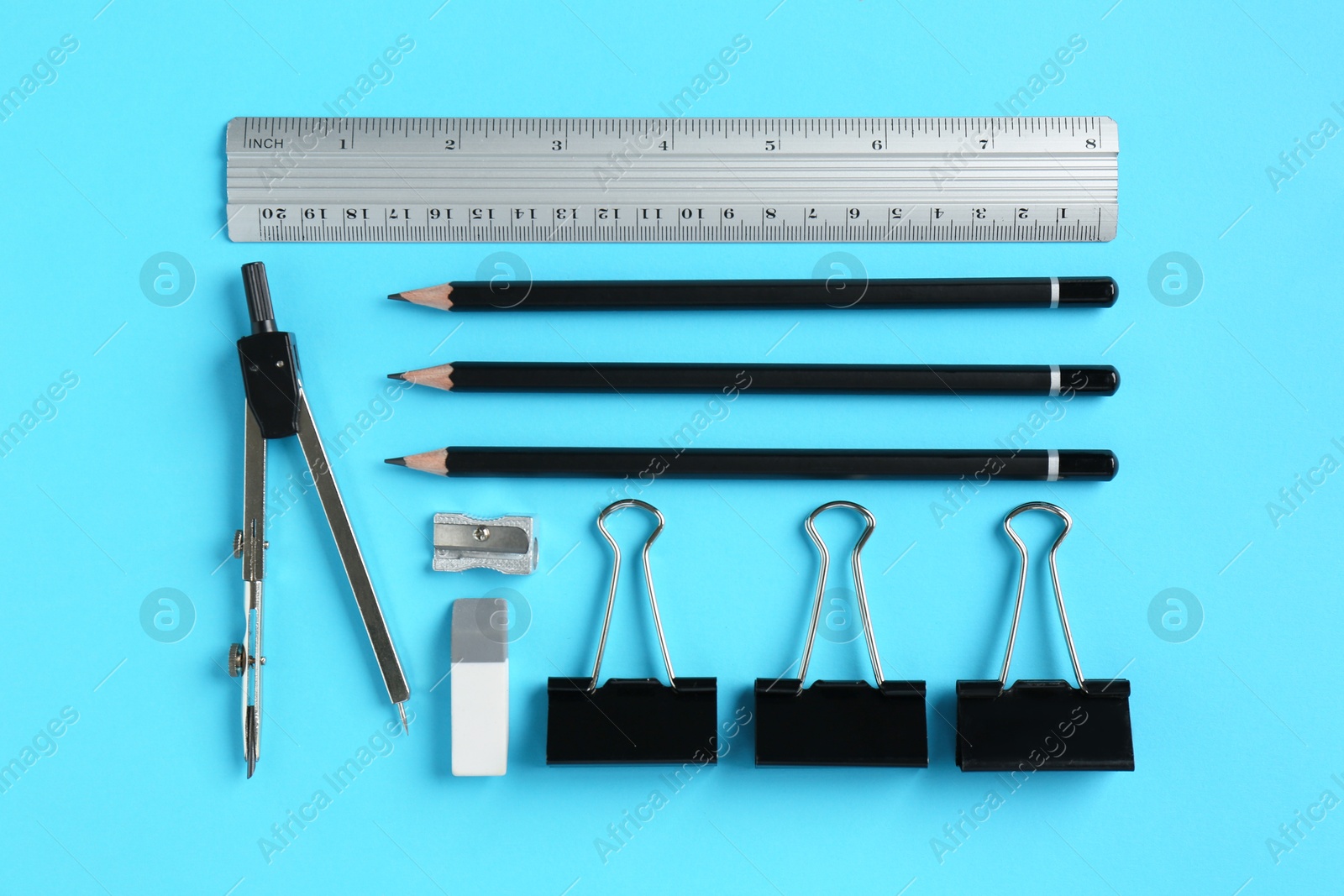 Photo of Flat lay composition with ruler and other stationery on light blue background