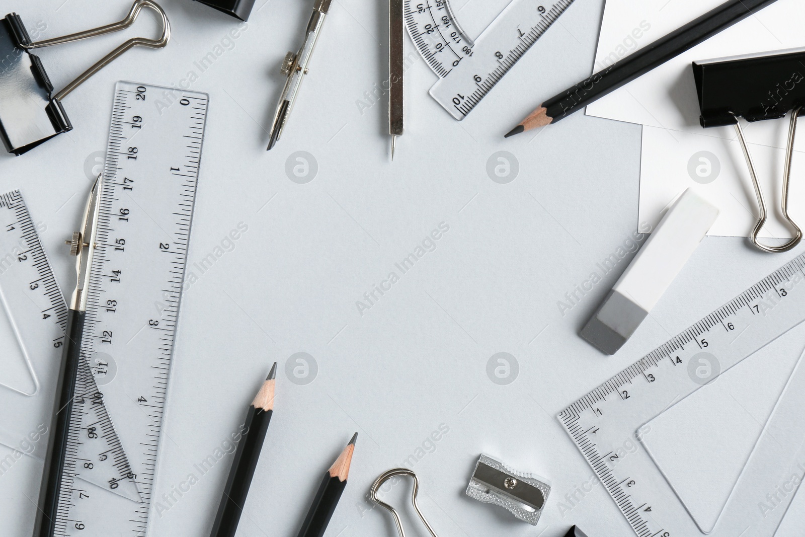 Photo of Flat lay composition with ruler and other stationery on light grey background, space for text