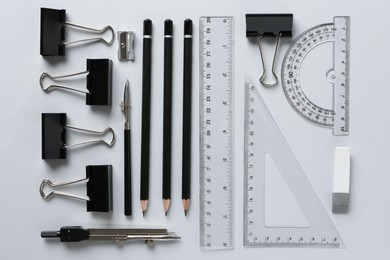 Photo of Flat lay composition with ruler and other stationery on light grey background