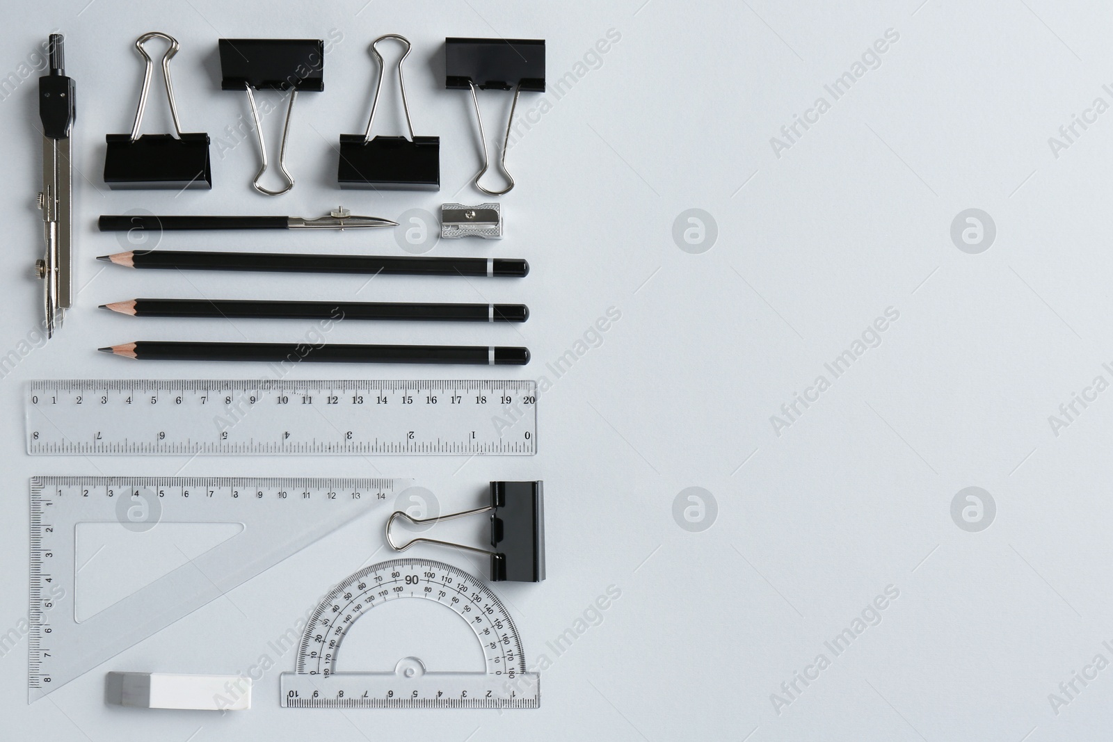 Photo of Flat lay composition with ruler and other stationery on light grey background, space for text