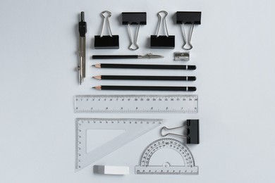 Photo of Flat lay composition with ruler and other stationery on light grey background