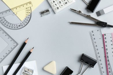 Photo of Flat lay composition with ruler and other stationery on light grey background, space for text