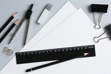 Photo of Flat lay composition with ruler and other stationery on light grey background