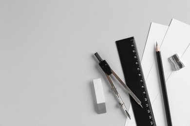 Photo of Flat lay composition with ruler and other stationery on light grey background, space for text