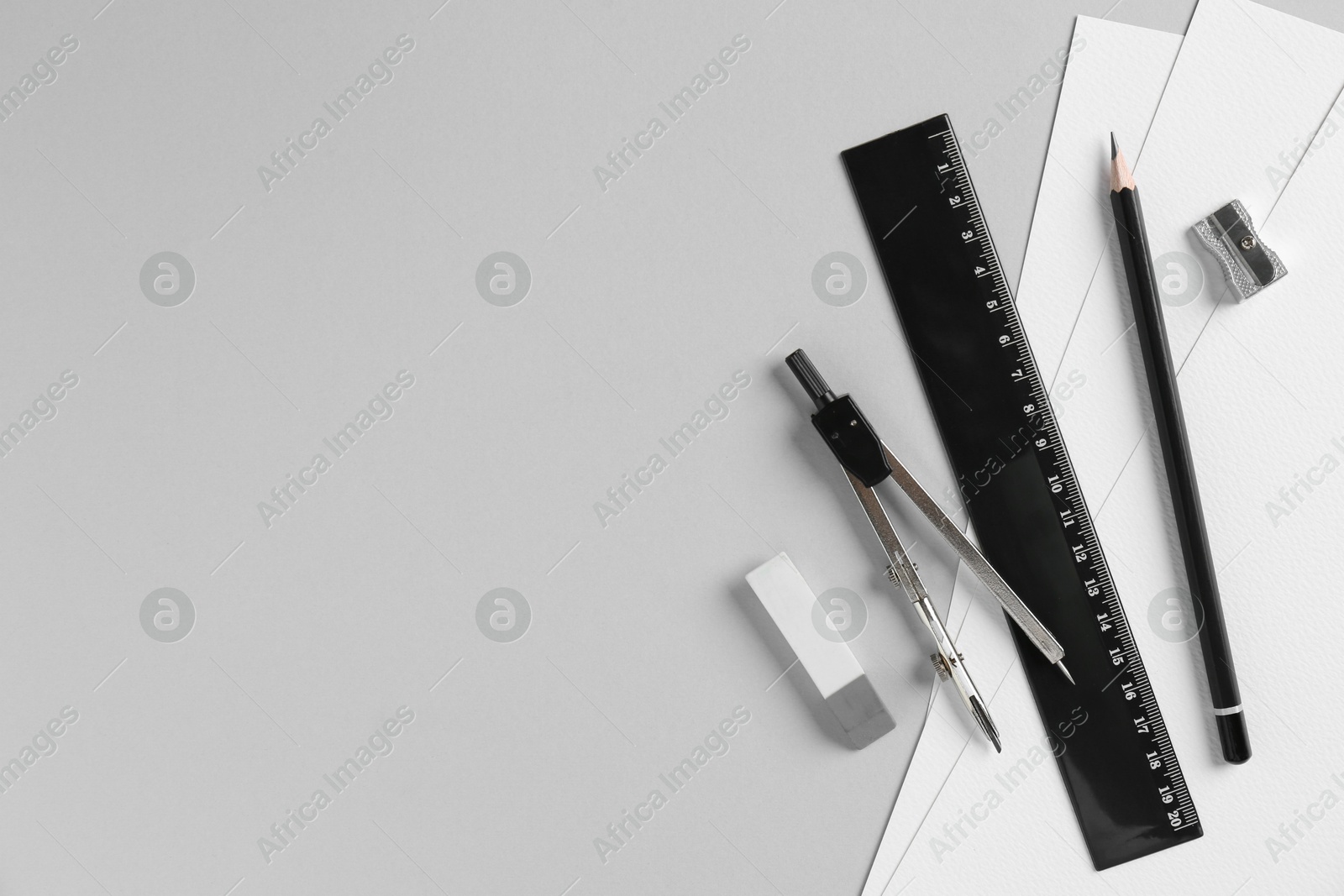 Photo of Flat lay composition with ruler and other stationery on light grey background, space for text