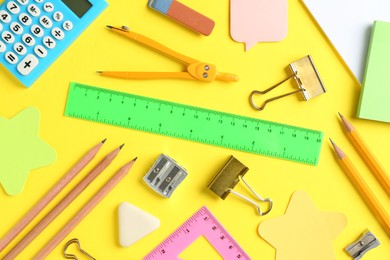 Photo of Flat lay composition with ruler and other stationery on yellow background