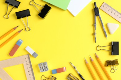 Photo of Flat lay composition with ruler and other stationery on yellow background, space for text