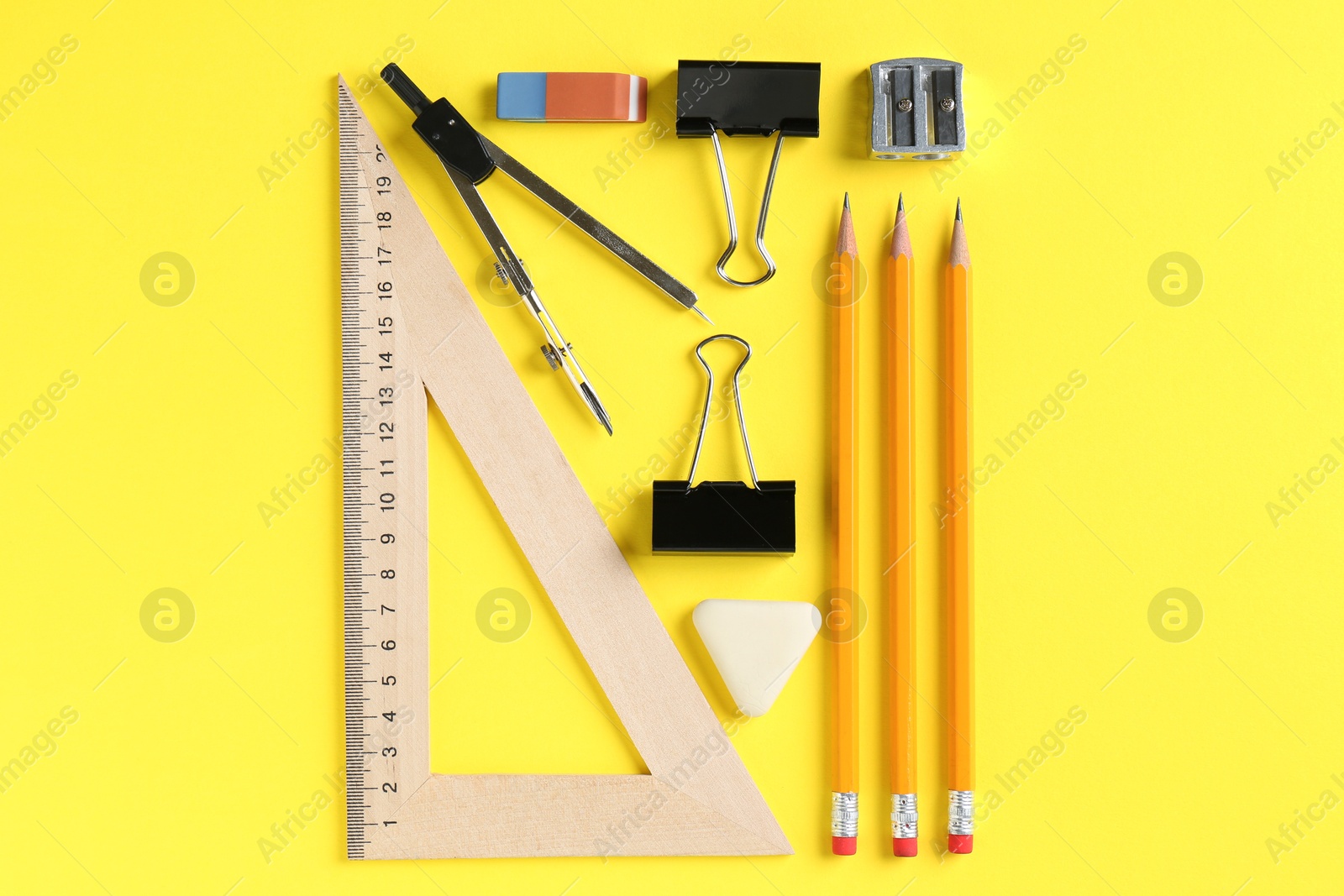 Photo of Flat lay composition with ruler and other stationery on yellow background