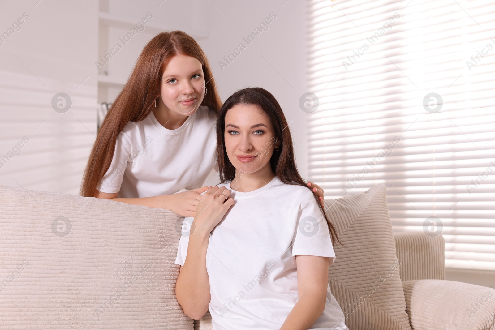 Photo of Portrait of beautiful mother with teenage daughter at home