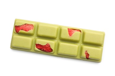 Photo of One tasty chocolate bar with pieces of strawberries isolated on white, top view