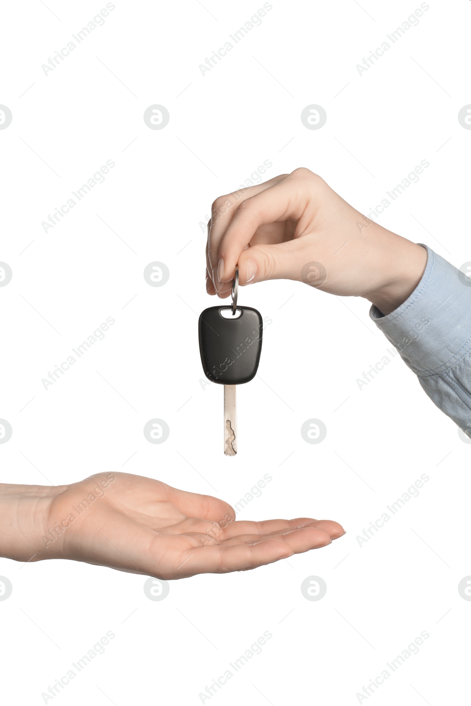 Photo of Dealer giving car key to customer on white background, closeup. Buying auto