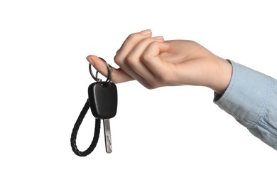 Woman with car key and keychain on white background, closeup