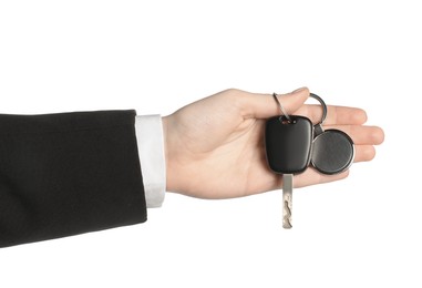 Woman with car key and keychain on white background, closeup