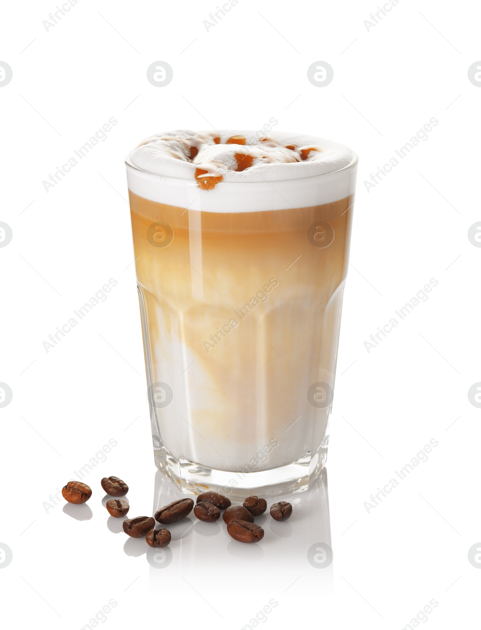 Photo of Tasty latte macchiato in glass and coffee beans isolated on white