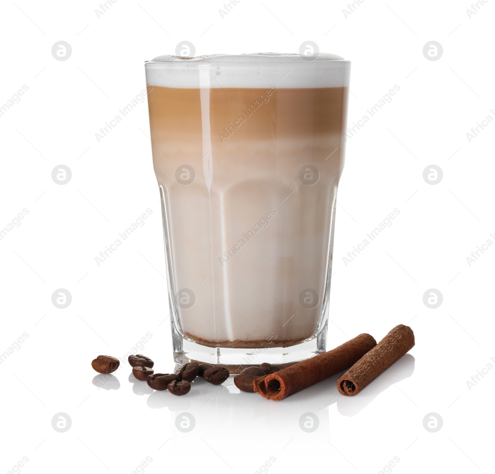 Photo of Tasty latte macchiato in glass, coffee beans and cinnamon isolated on white