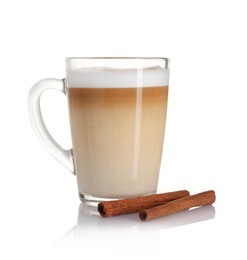 Photo of Tasty latte macchiato in glass cup and cinnamon isolated on white