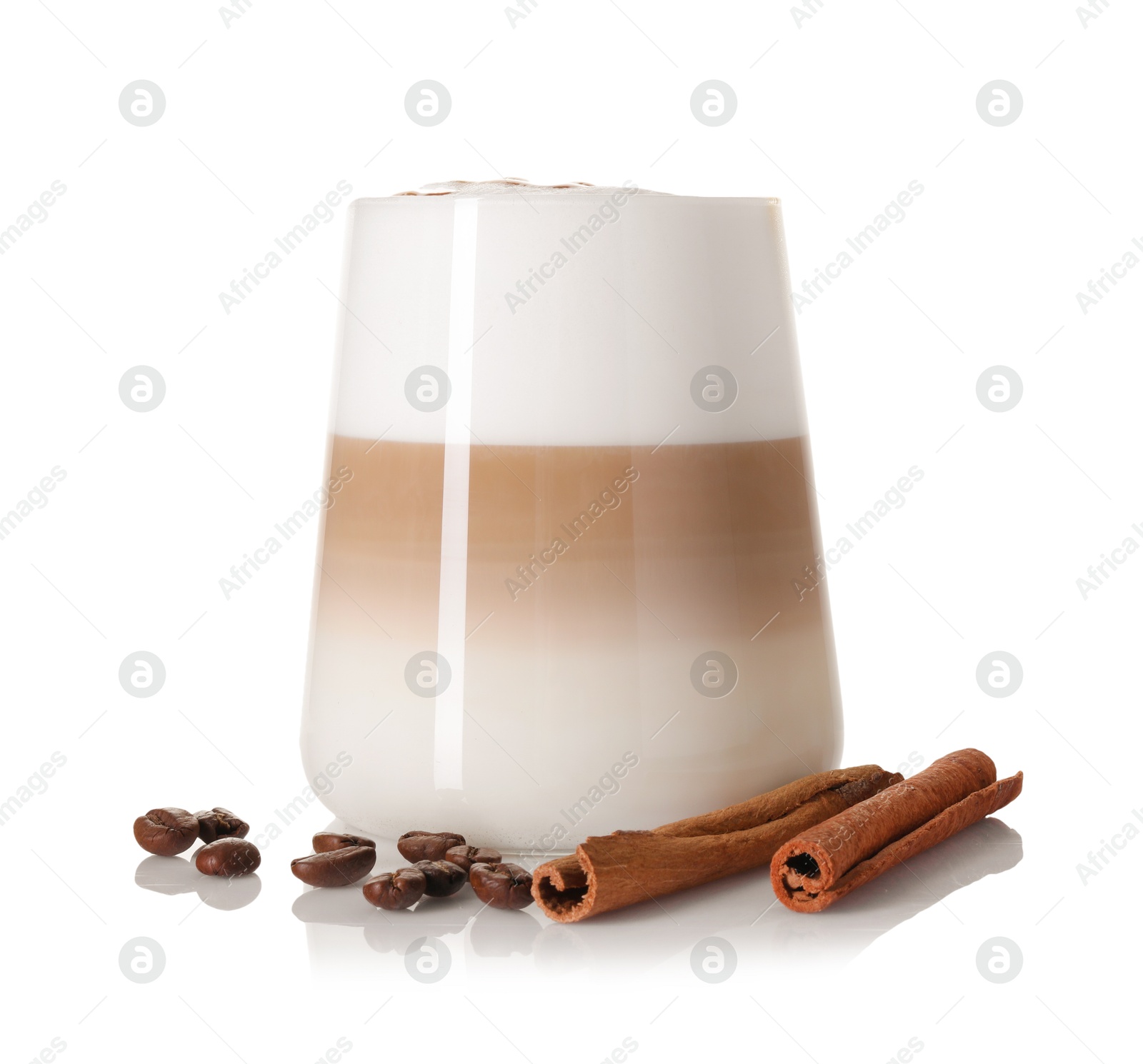 Photo of Tasty latte macchiato in glass, coffee beans and cinnamon isolated on white