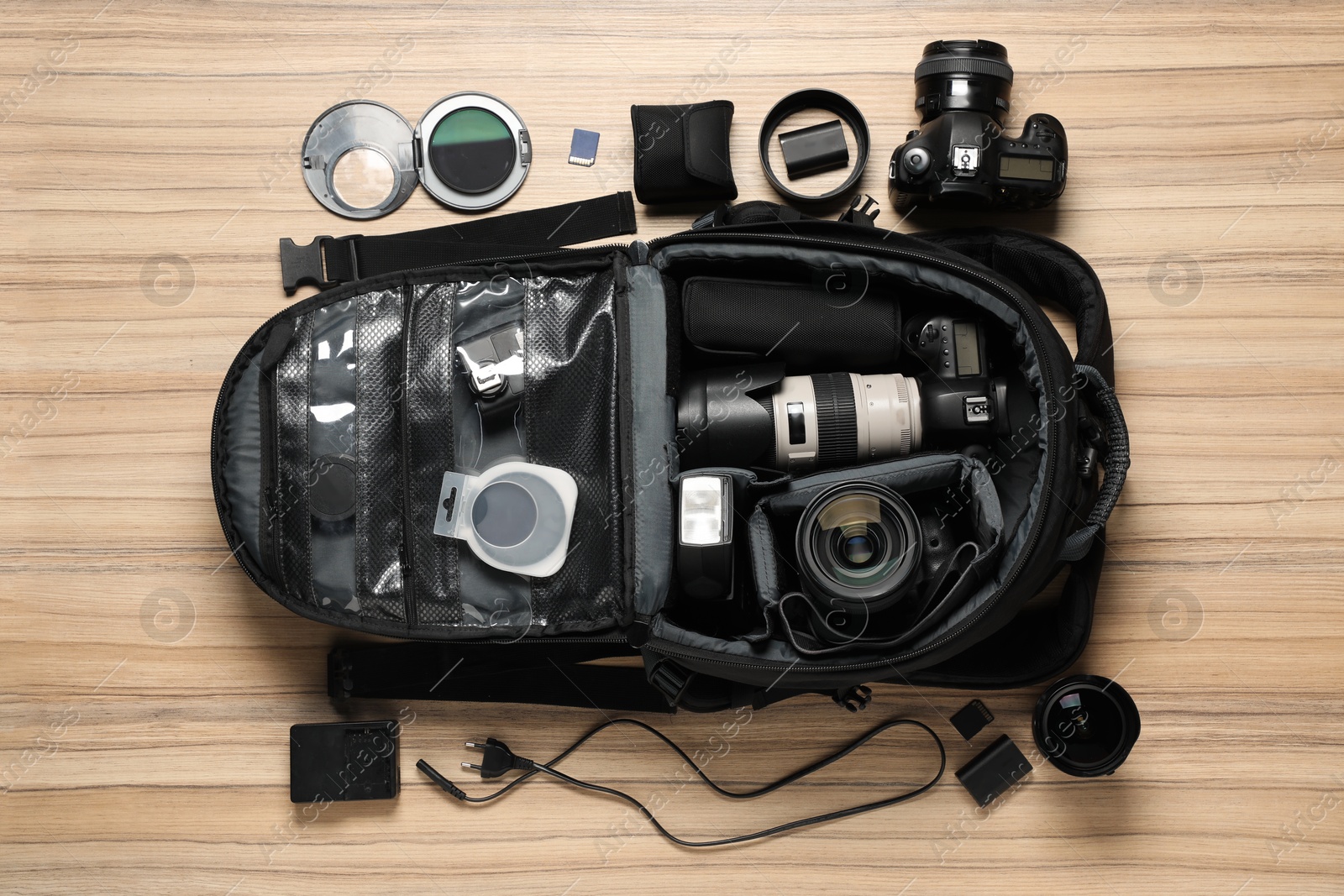 Photo of Photographer's equipment on wooden background, flat lay