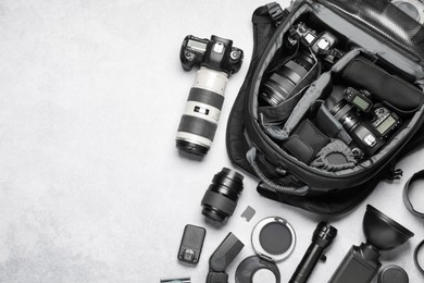 Photo of Photographer's equipment on grey background, flat lay. Space for text