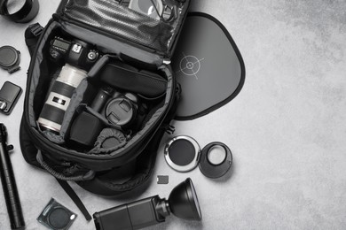 Photographer's equipment on grey background, flat lay. Space for text