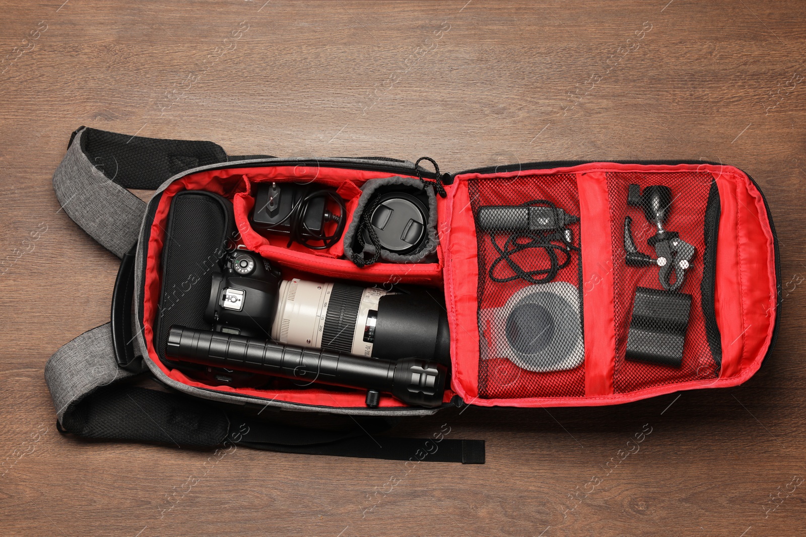 Photo of Photographer's equipment on wooden background, flat lay