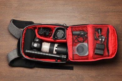 Photo of Photographer's equipment on wooden background, flat lay