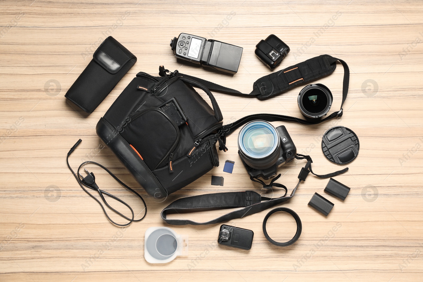 Photo of Photographer's equipment on wooden background, flat lay