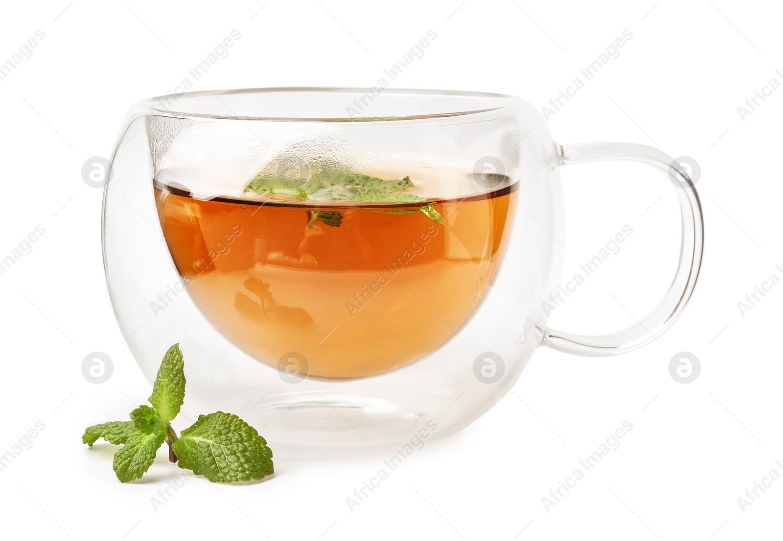 Photo of Tasty mint tea in cup and fresh leaves isolated on white