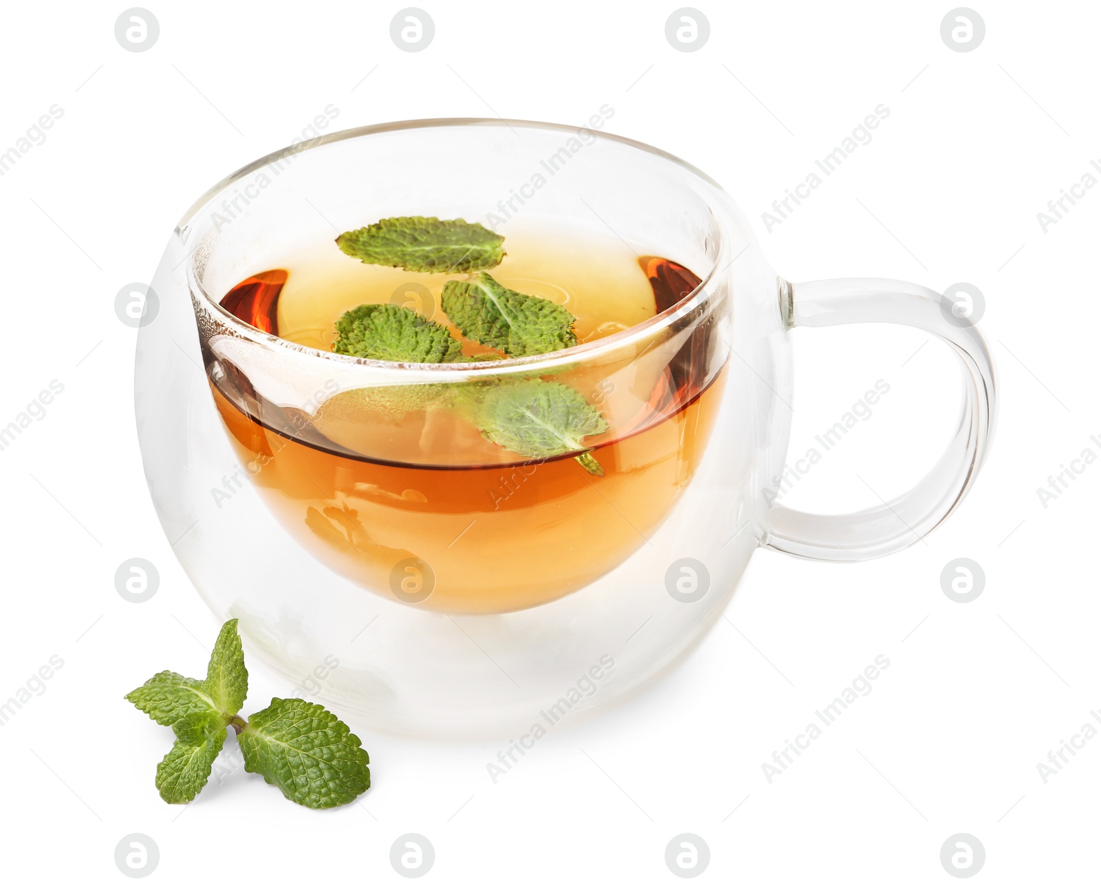 Photo of Tasty mint tea in cup and fresh leaves isolated on white