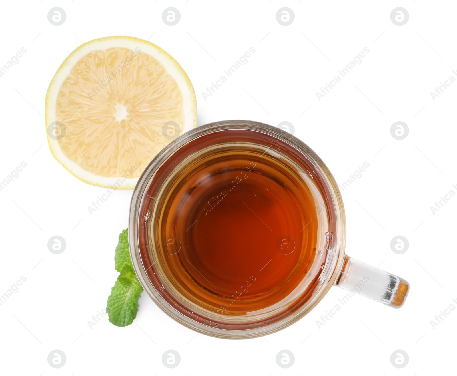 Photo of Tasty mint tea in cup, lemon and fresh leaves isolated on white, top view