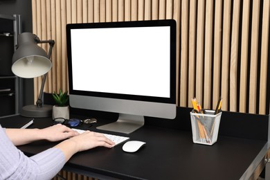 Photo of Woman working on computer at desk indoors, closeup