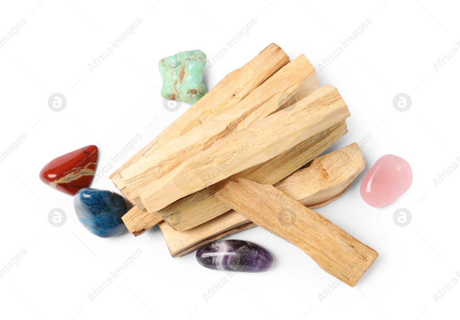 Photo of Palo santo sticks and gemstones isolated on white, top view