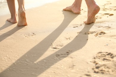 Photo of Young couple walking together on beach, closeup