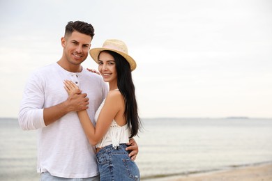 Photo of Lovely couple spending time together on beach. Space for text