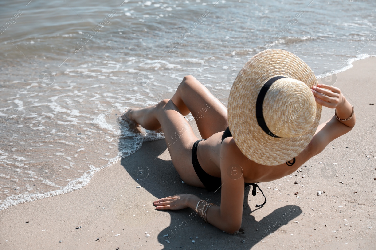 Photo of Young woman with beautiful body on sandy beach