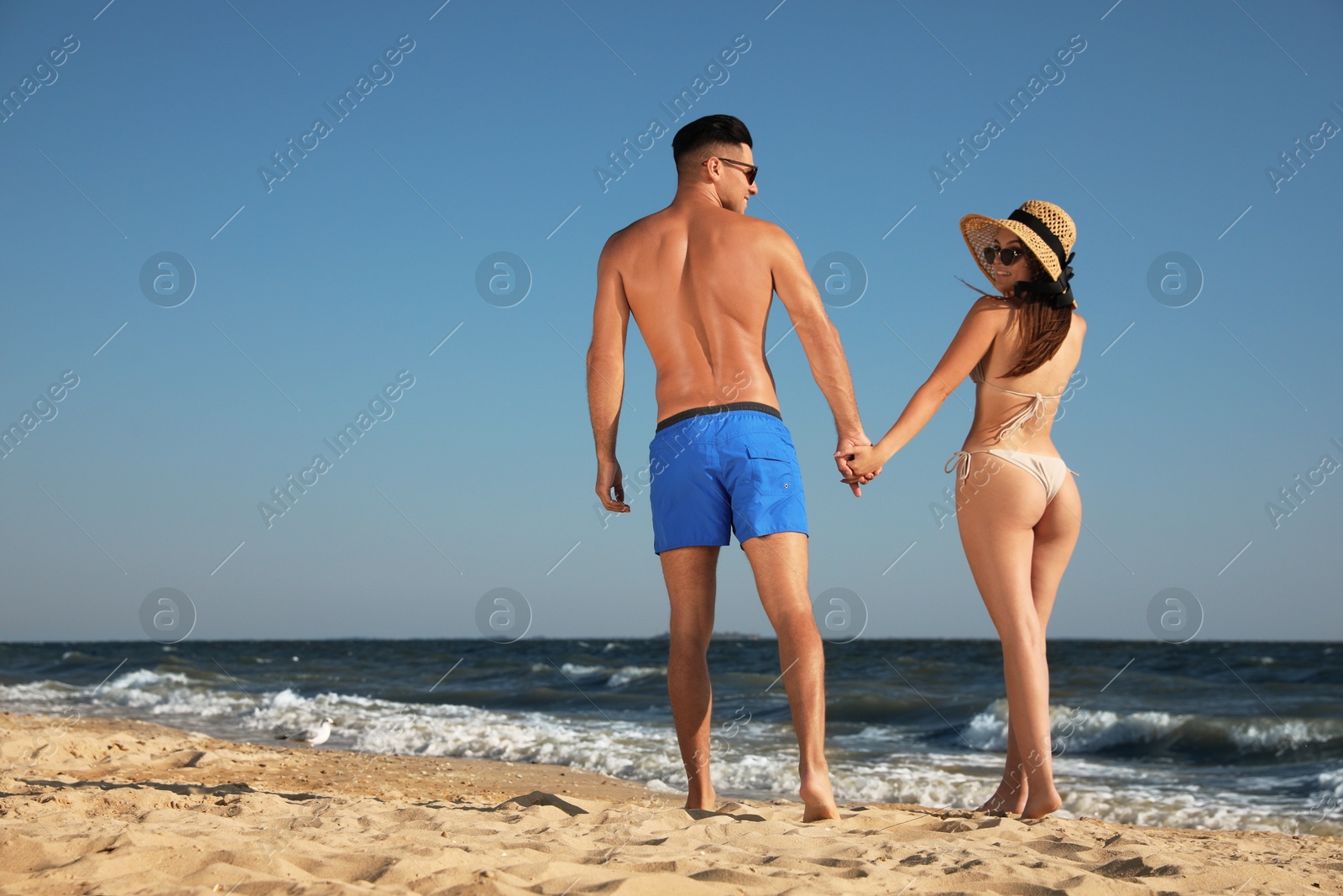 Photo of Lovely couple spending time together on beach