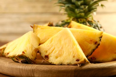 Photo of Cut fresh ripe pineapple on table, closeup