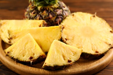 Photo of Cut fresh ripe pineapple on table, closeup