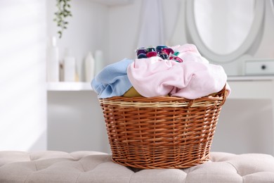 Photo of Laundry detergent and clothes in basket indoors