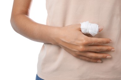 Photo of Woman with medical bandage on finger against white background, closeup