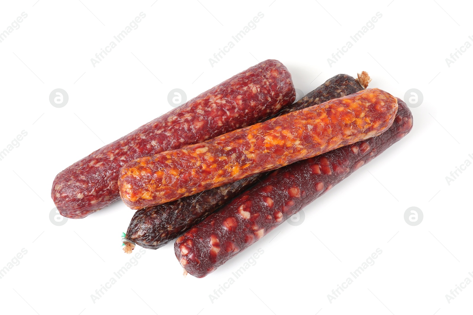 Photo of Many different dry cured sausages isolated on white, top view