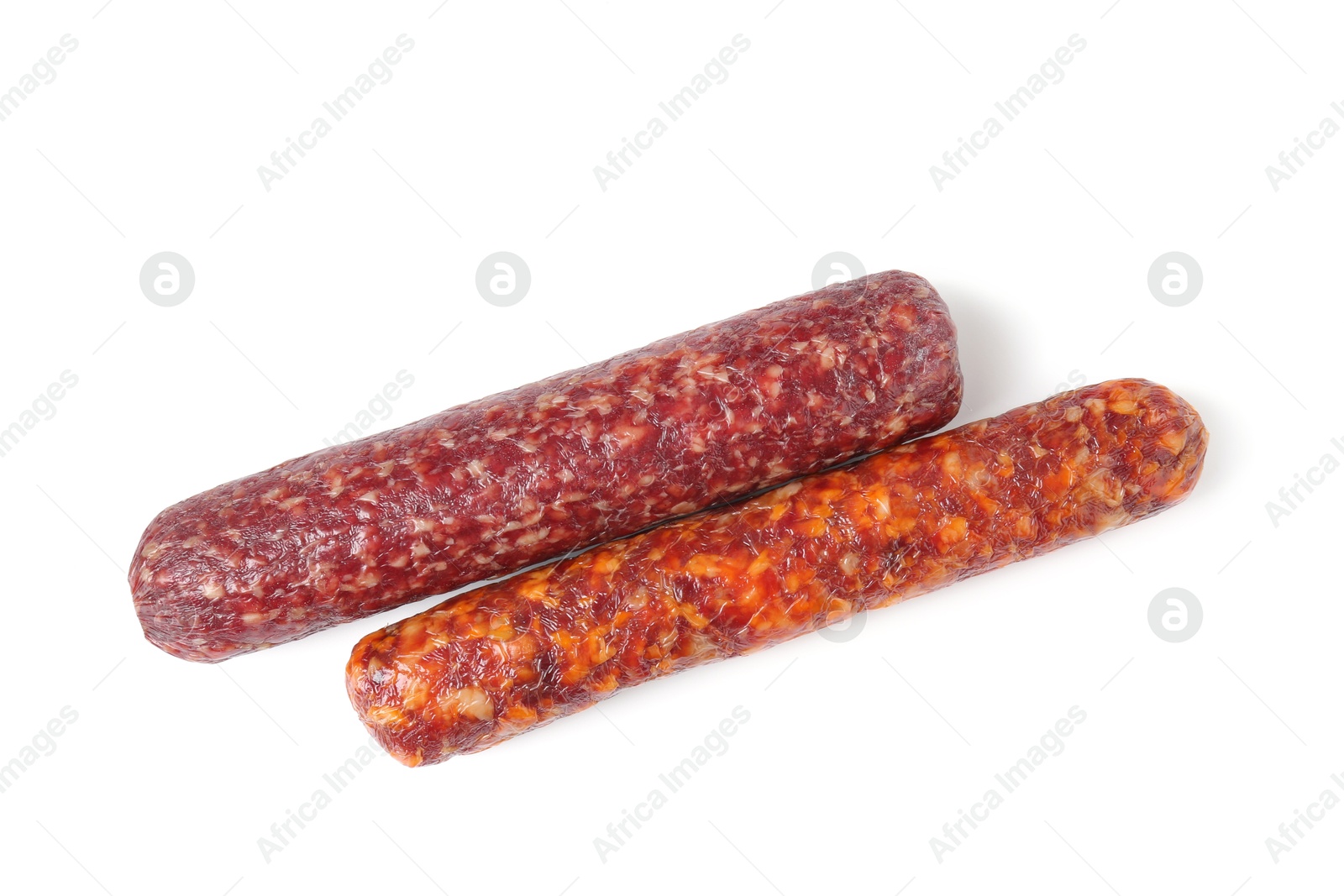 Photo of Delicious dry cured sausages isolated on white, top view