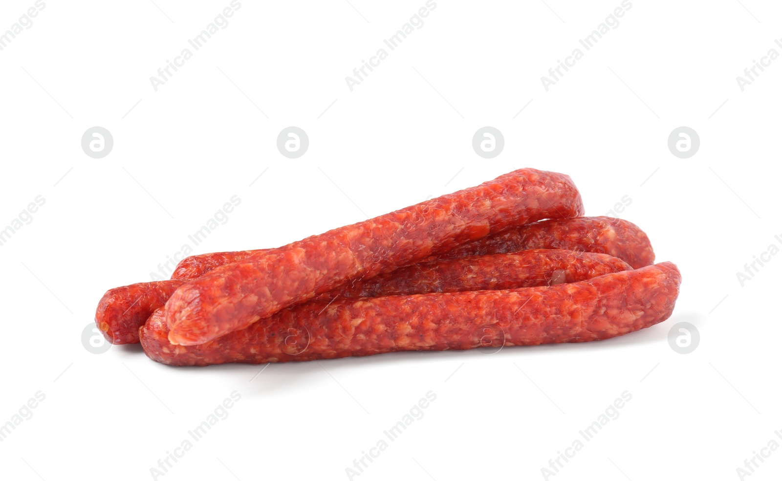 Photo of Many thin dry cured sausages isolated on white